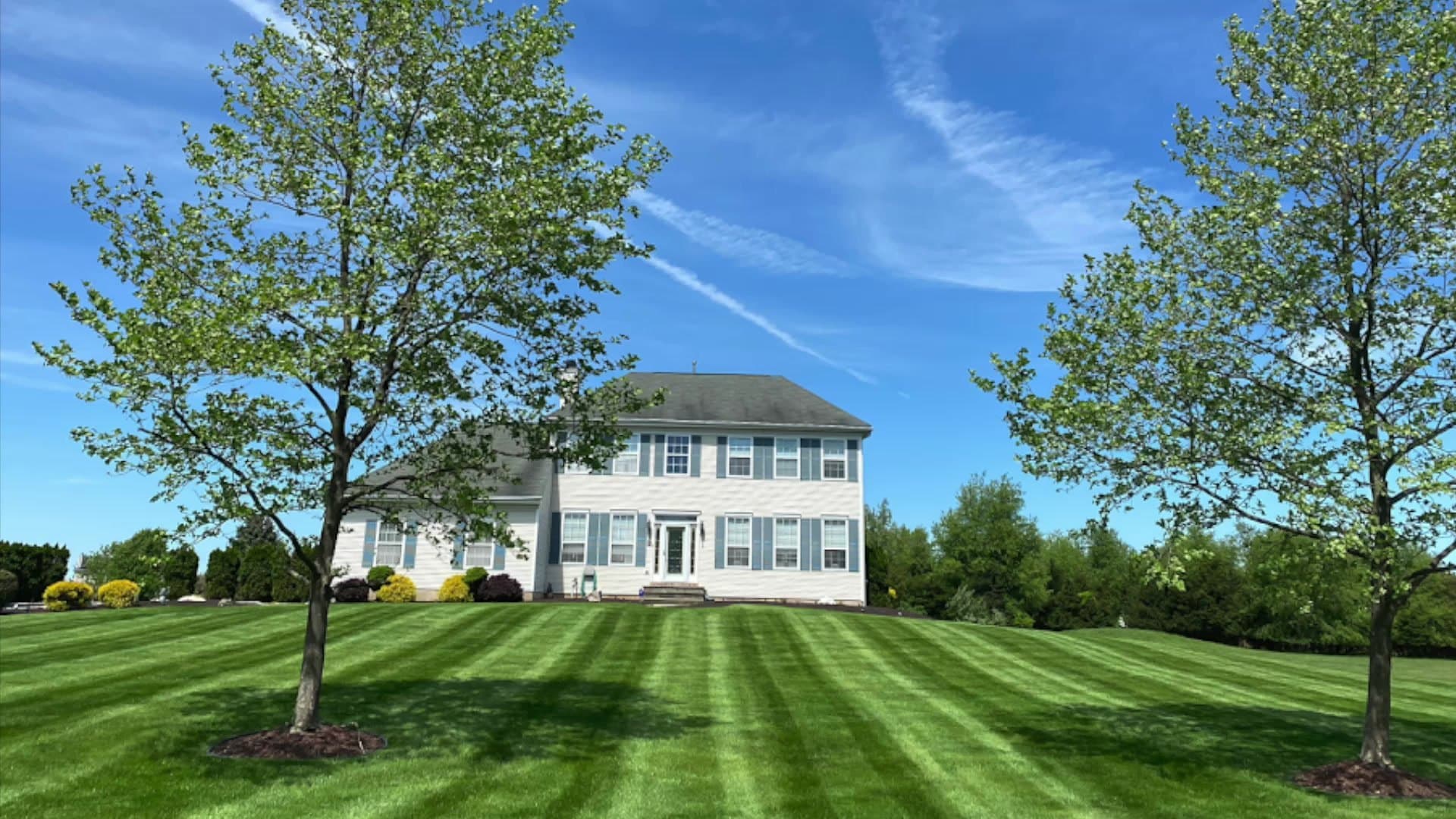Professionally striped green lawn in front of a Somerset-area home
